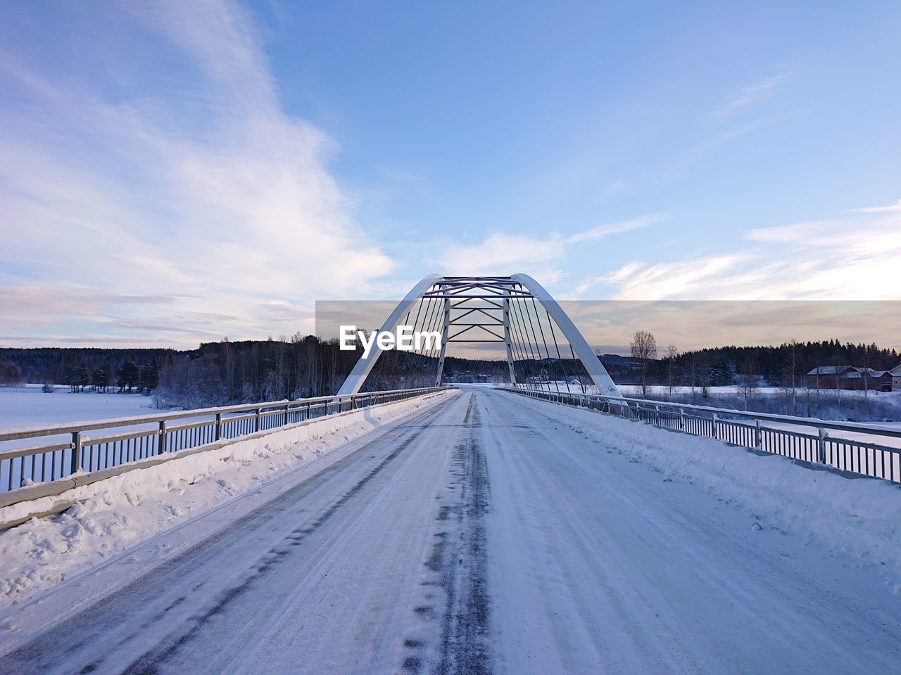Snow covered bridge against sky
