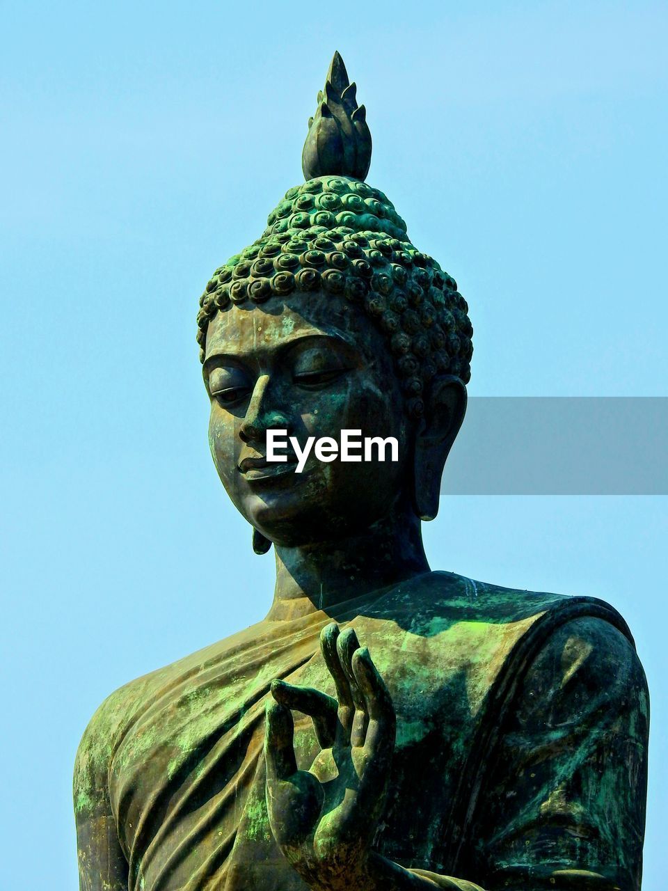 CLOSE-UP OF STATUE AGAINST CLEAR SKY