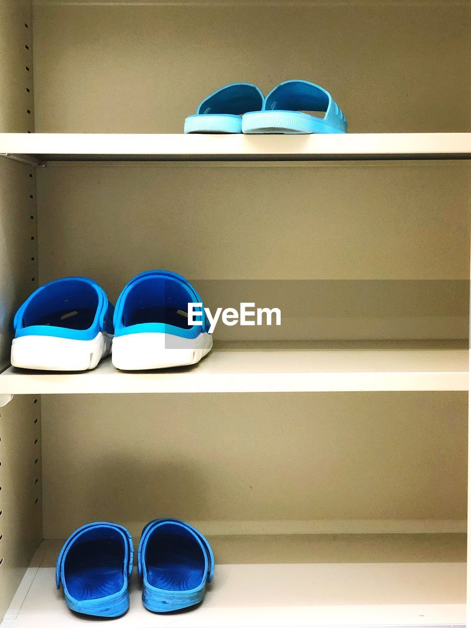 CLOSE-UP OF SHOES ON BLUE FLOOR