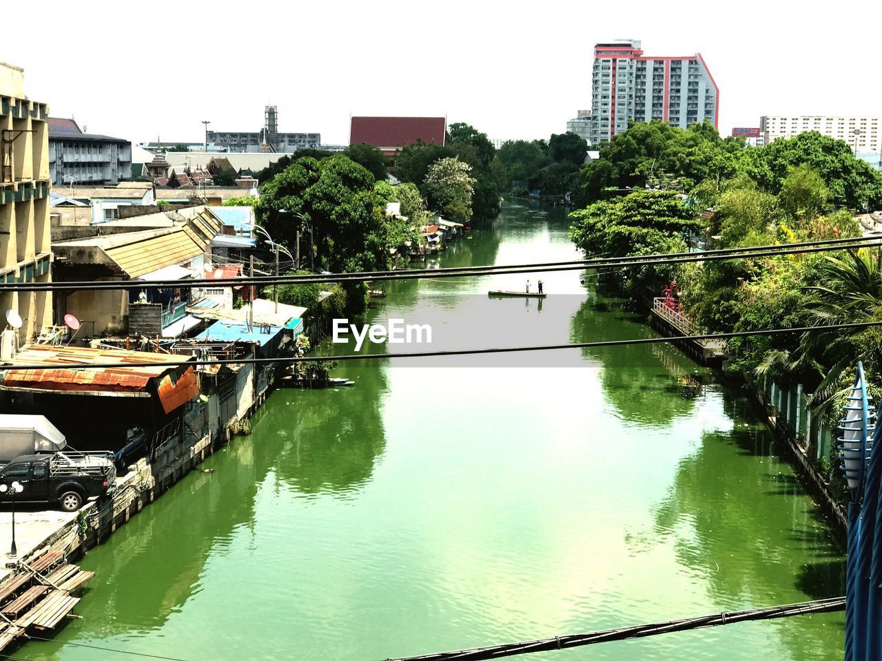 Scenic view of river in city against clear sky