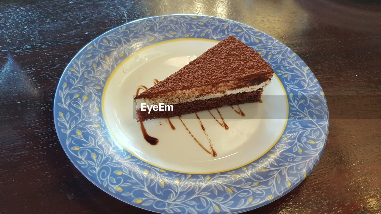 High angle view of tiramisu cake slice in plate