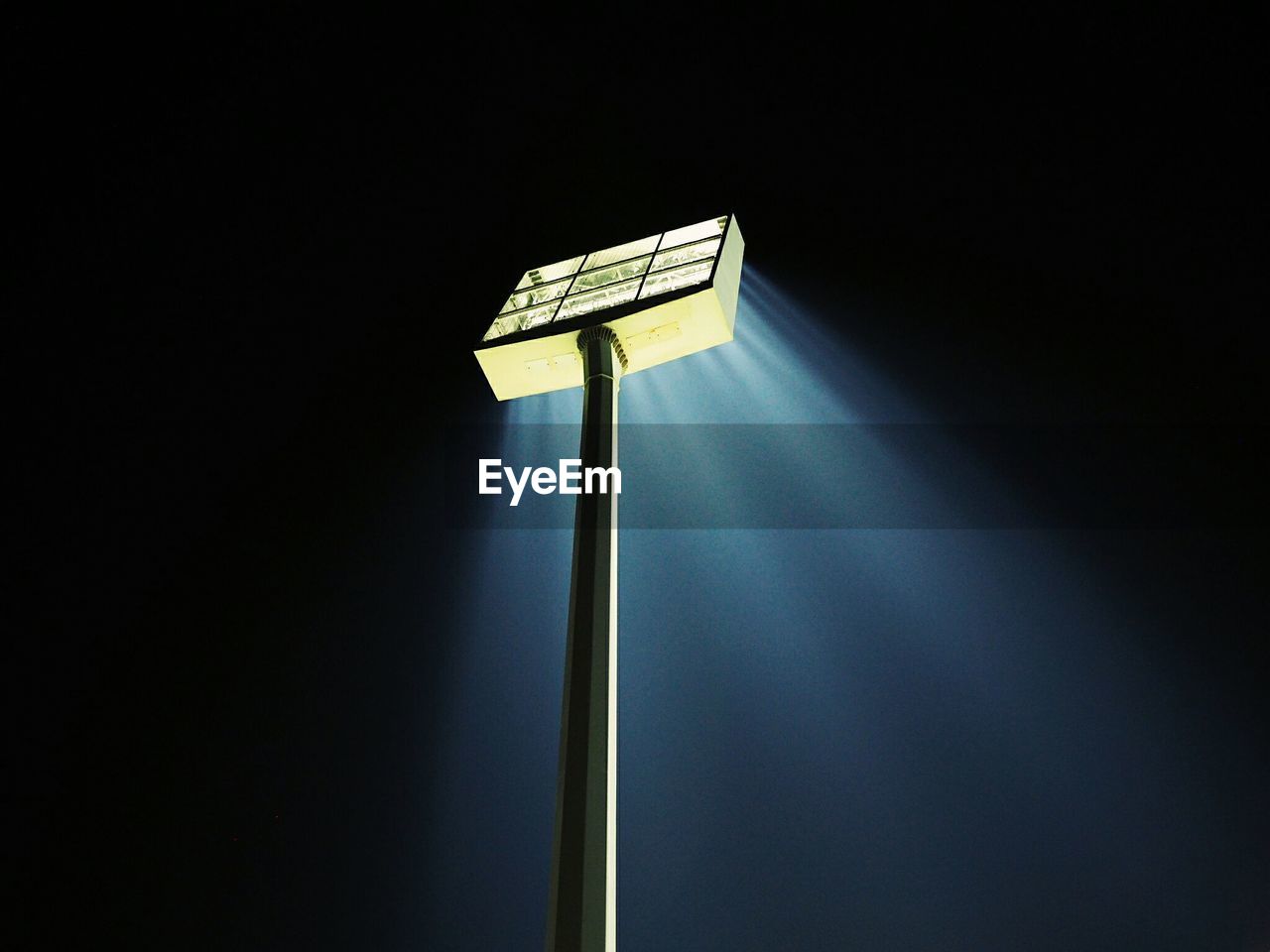 Low angle view of illuminated floodlight against sky