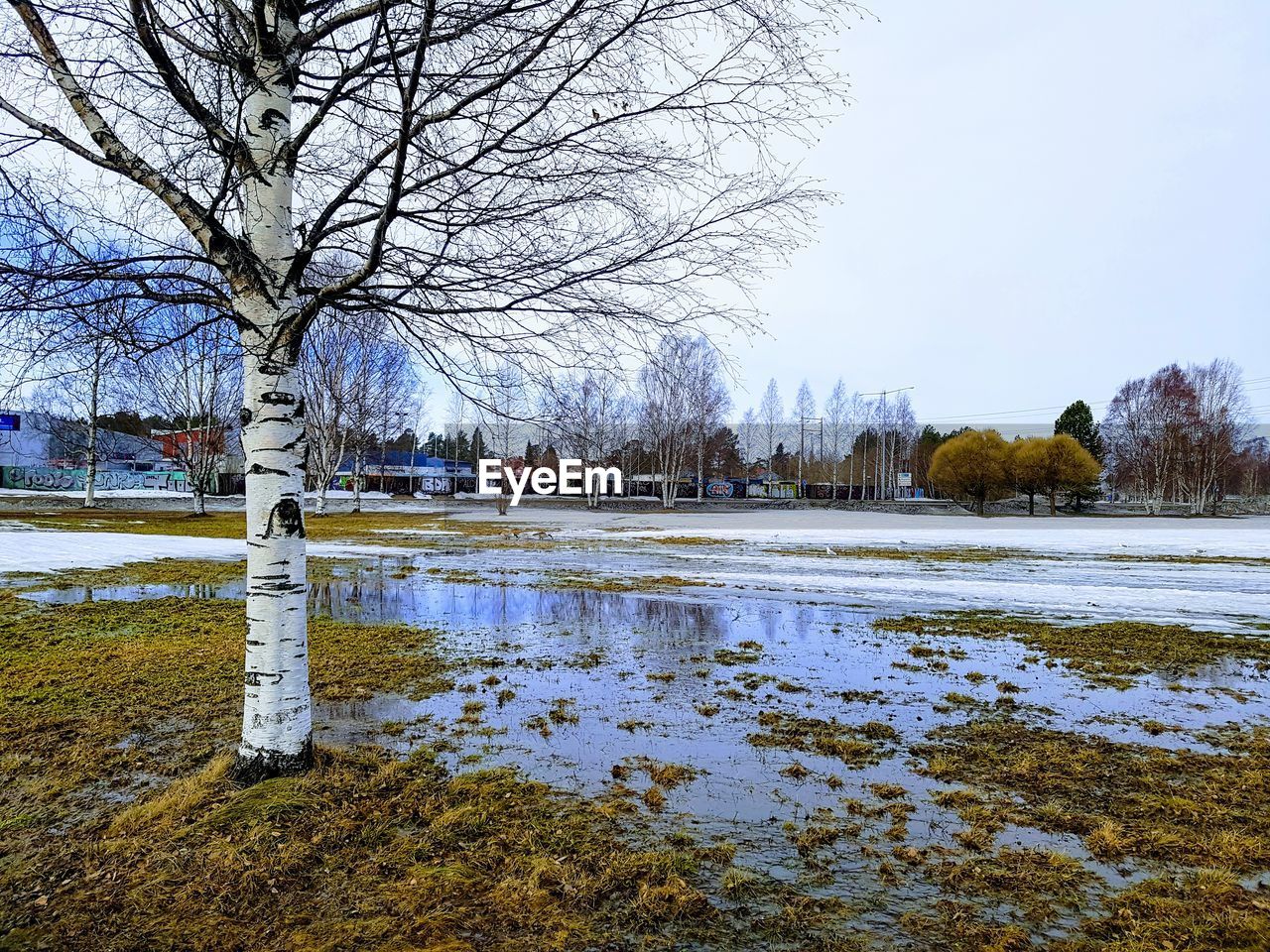 FROZEN LAKE AGAINST CLEAR SKY DURING WINTER