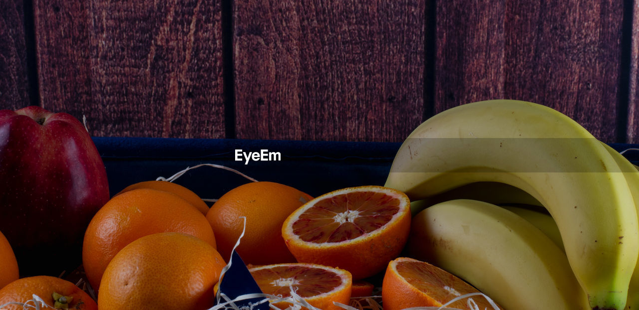 fruit, healthy eating, food and drink, food, wellbeing, freshness, citrus fruit, produce, banana, plant, orange color, orange, no people, indoors, still life photography, still life, grapefruit, wood, painting, slice