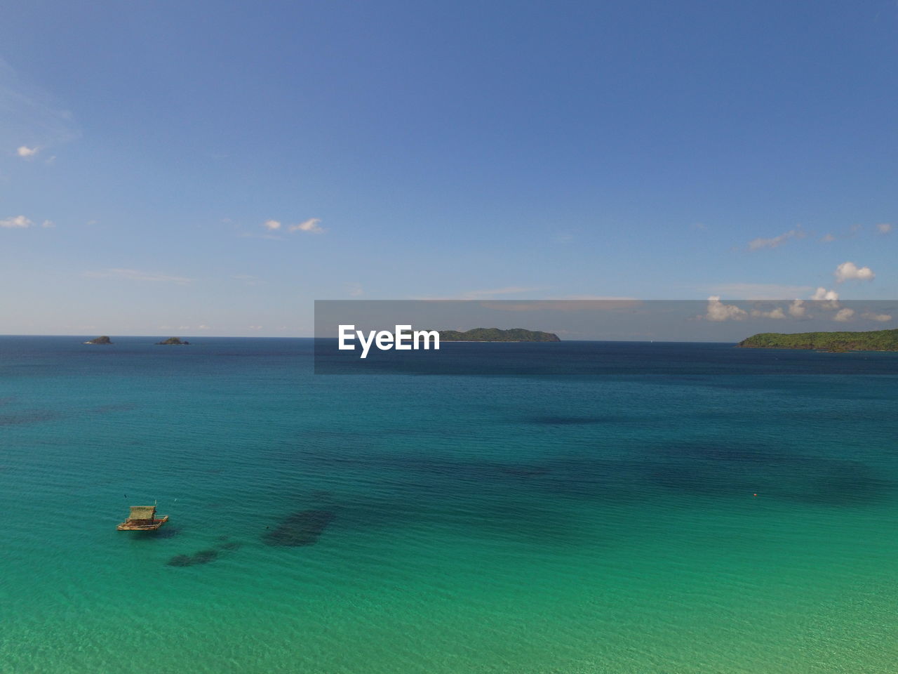 Scenic view of sea against blue sky