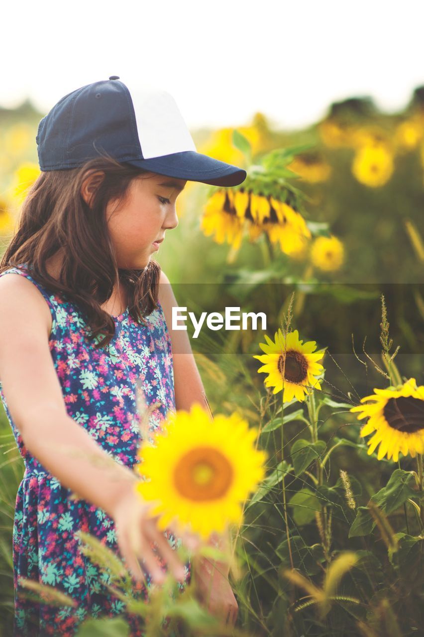 Close-up of girl on sunflower field