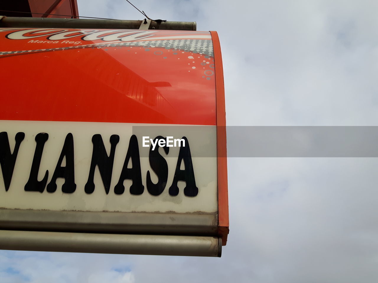 Low angle view of sign board against sky