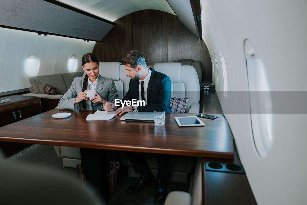 Business person sitting in airplane