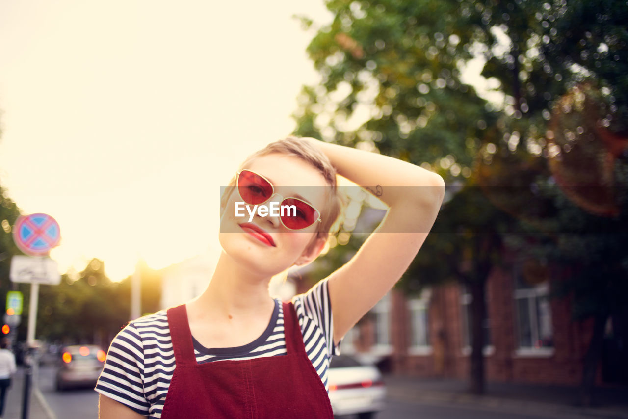 PORTRAIT OF BEAUTIFUL WOMAN AGAINST TREES