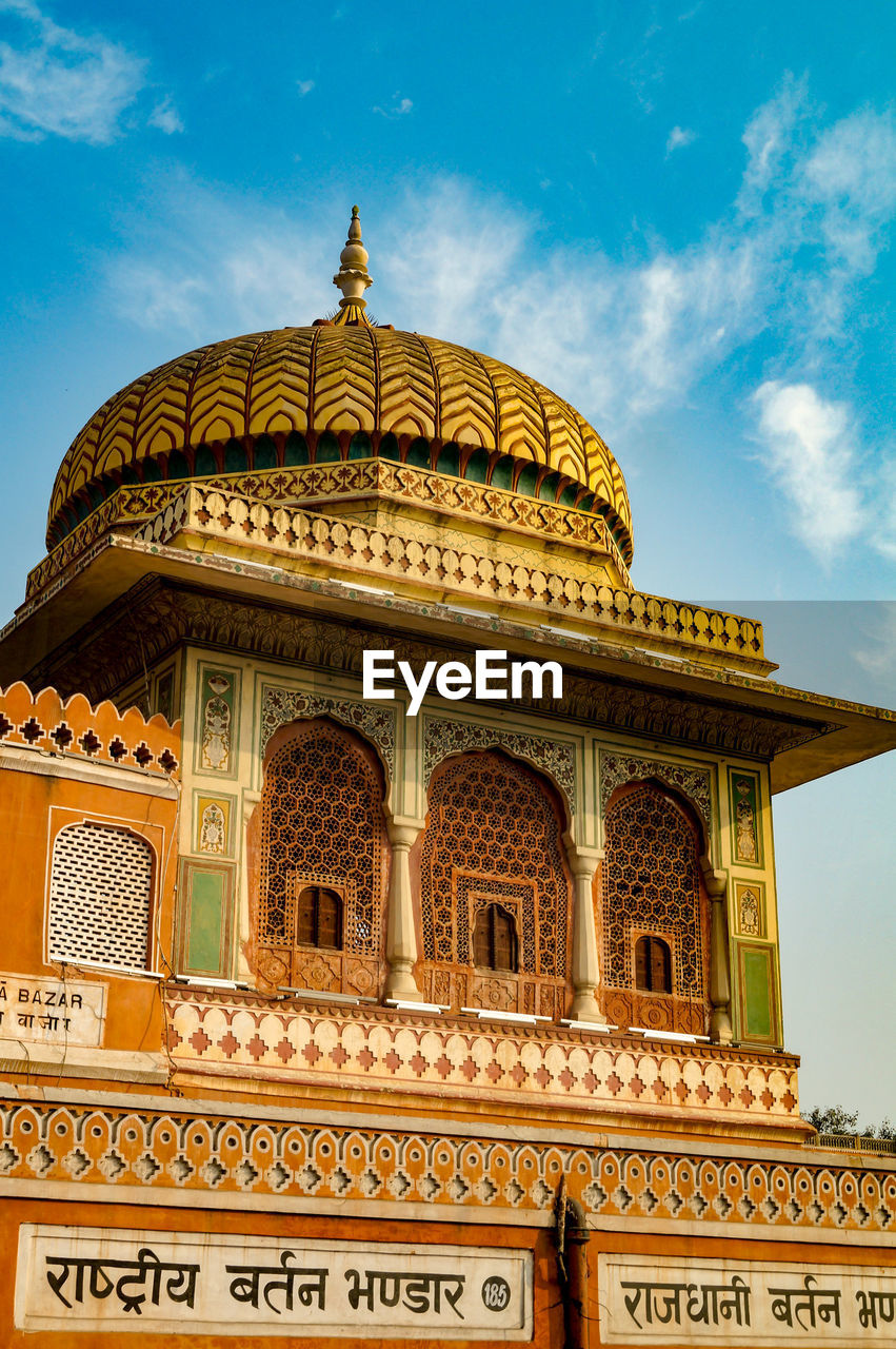 Pawan mahal in jaipur rajasthan with blue cloudy sky