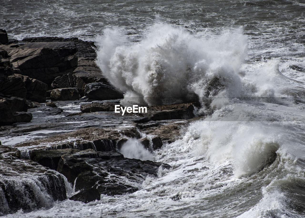 Waves splashing on rocks at shore