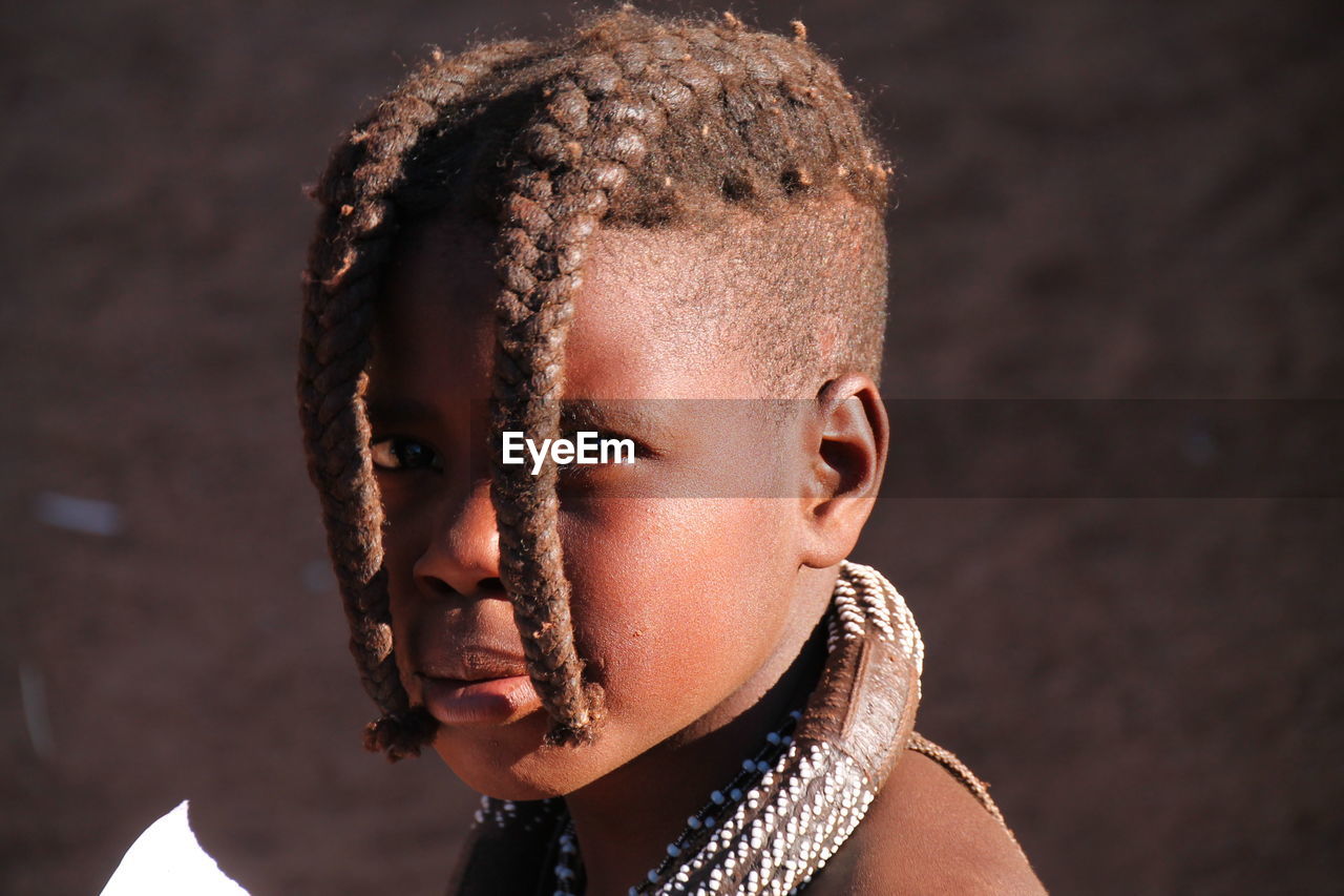 Close-up portrait of girl with dreadlocks