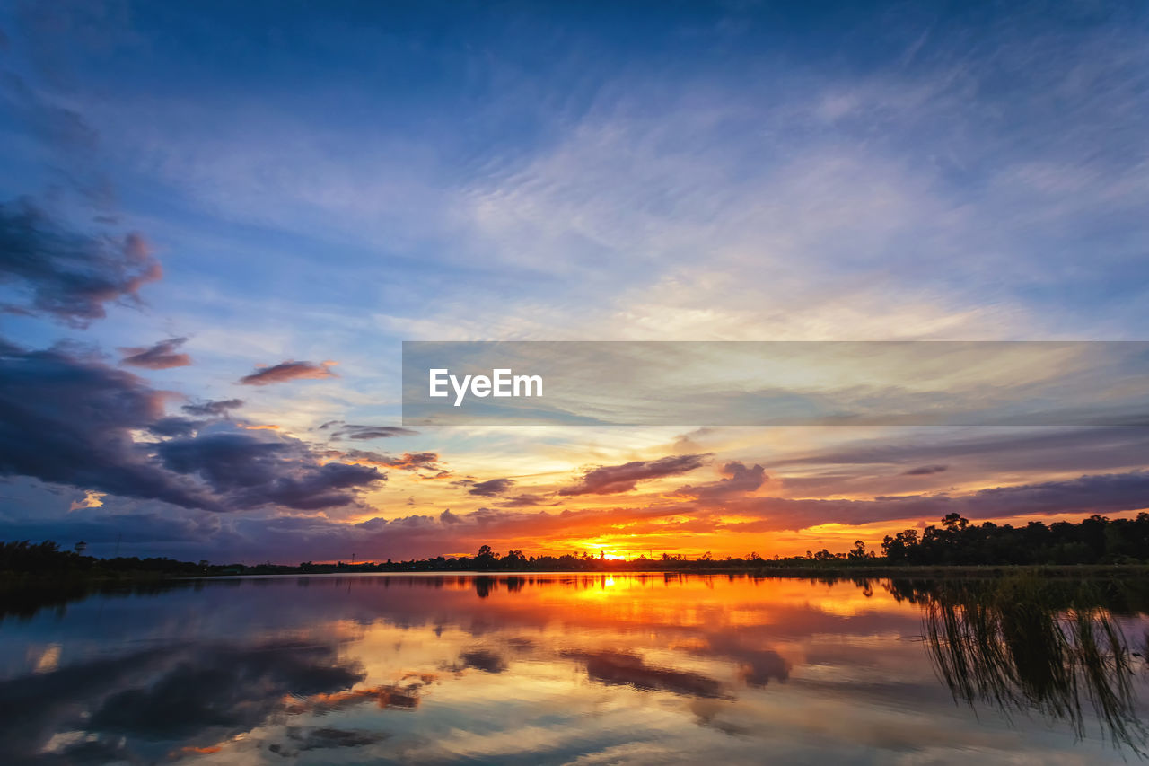 SCENIC VIEW OF LAKE AGAINST ORANGE SKY