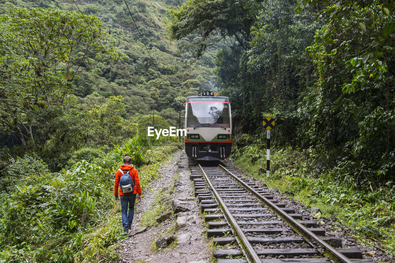 Hiker on train tracks that lead up to aguas calientes