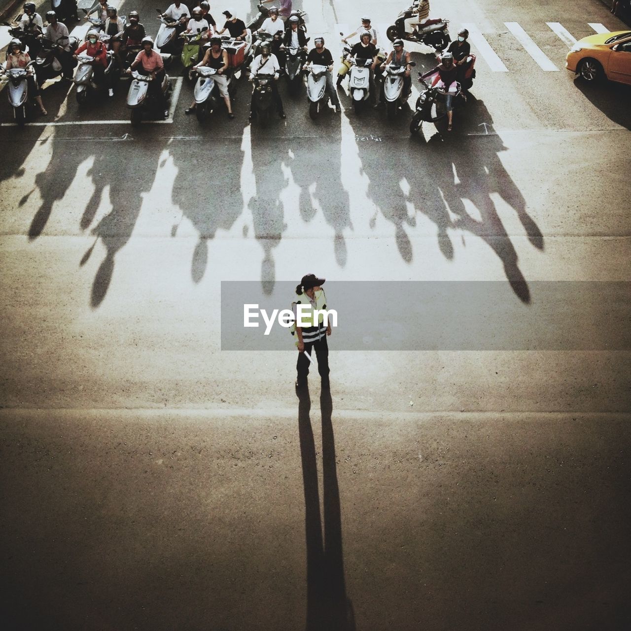 High angle view of woman traffic cop on road in city