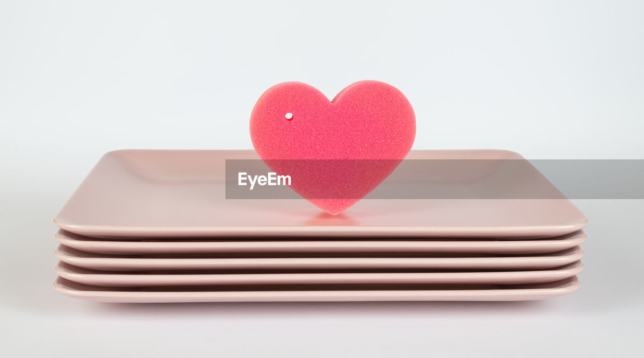 CLOSE-UP OF HEART SHAPE OVER PINK BACKGROUND