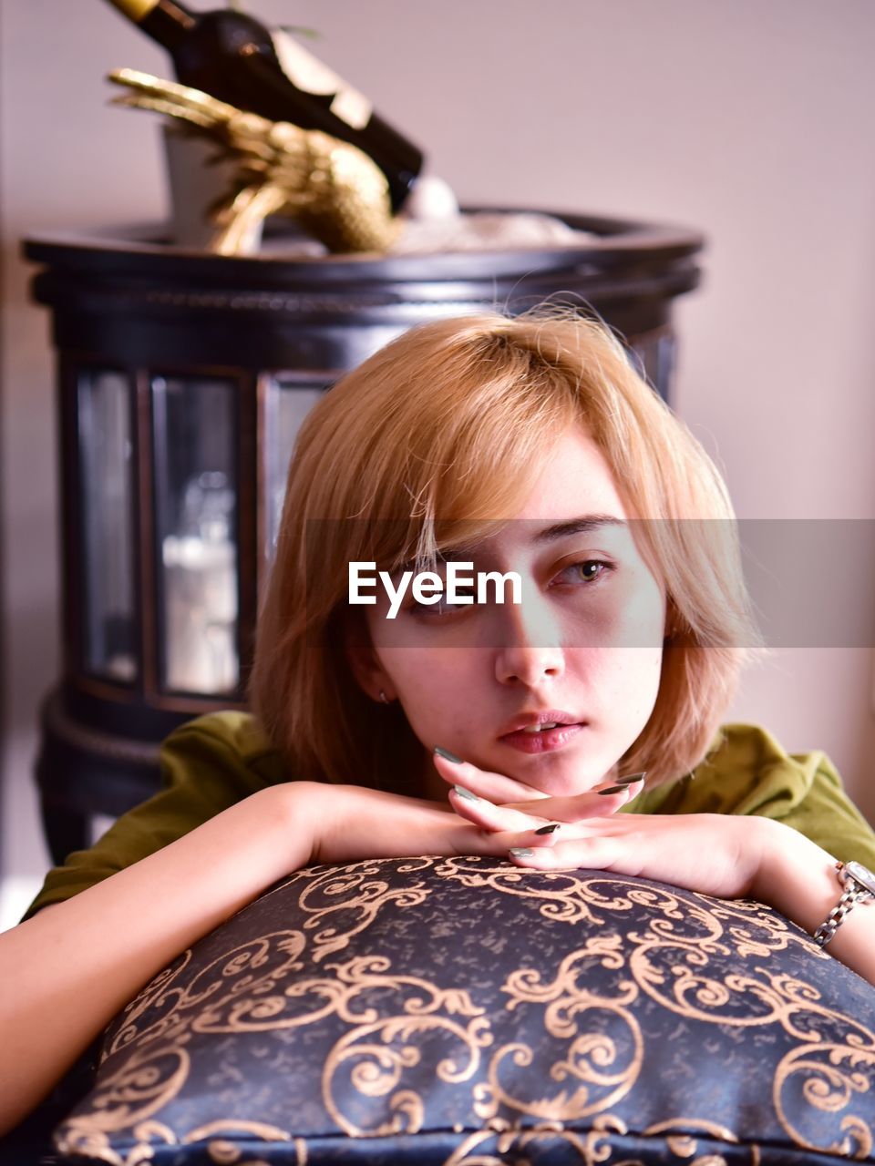 Portrait of beautiful young woman sitting at home