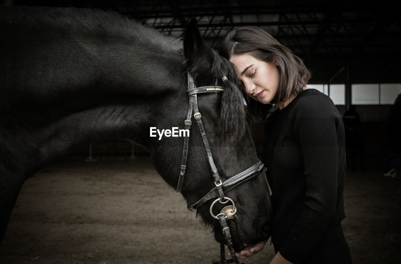 Woman standing with horse