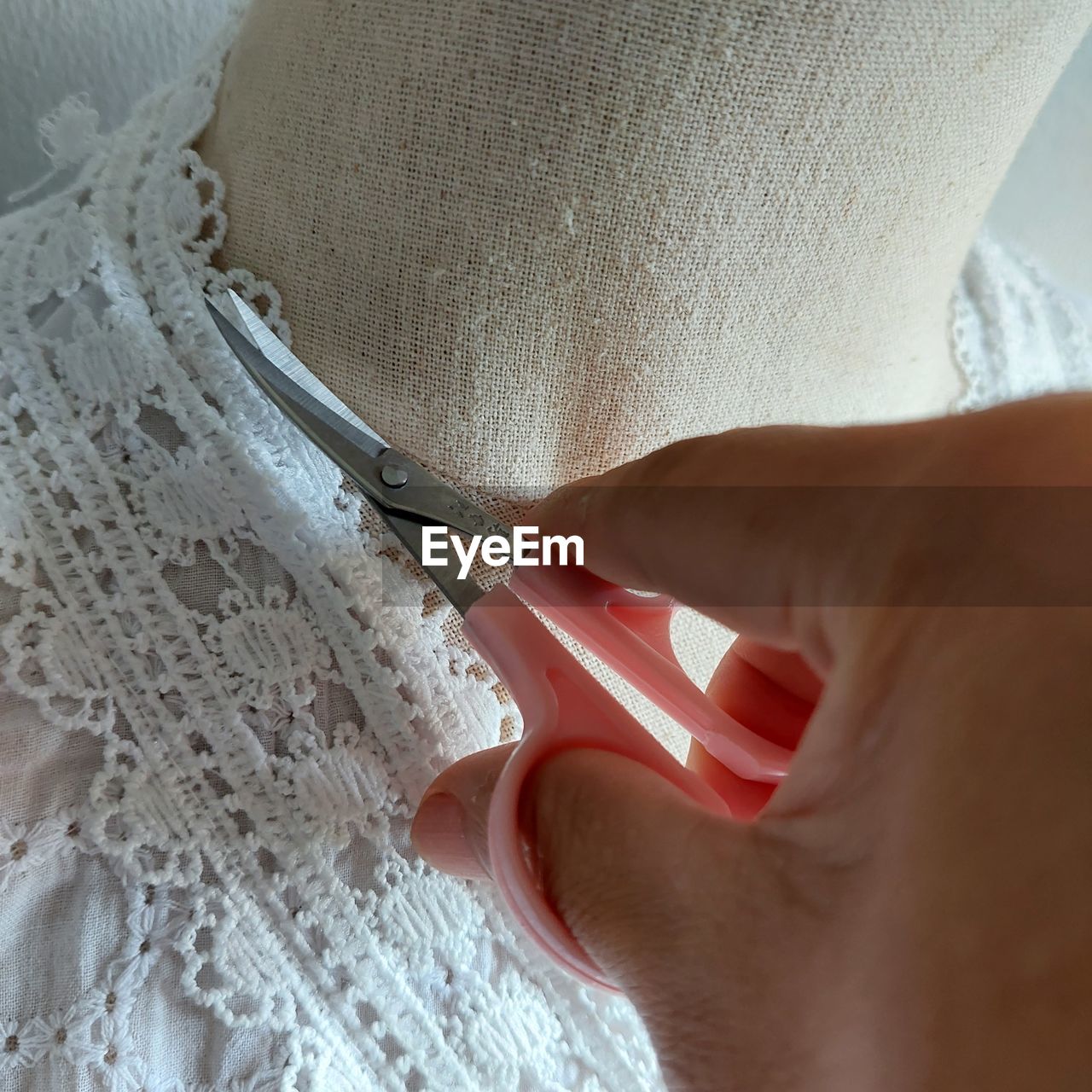 Woman hand checking dress for display for sale