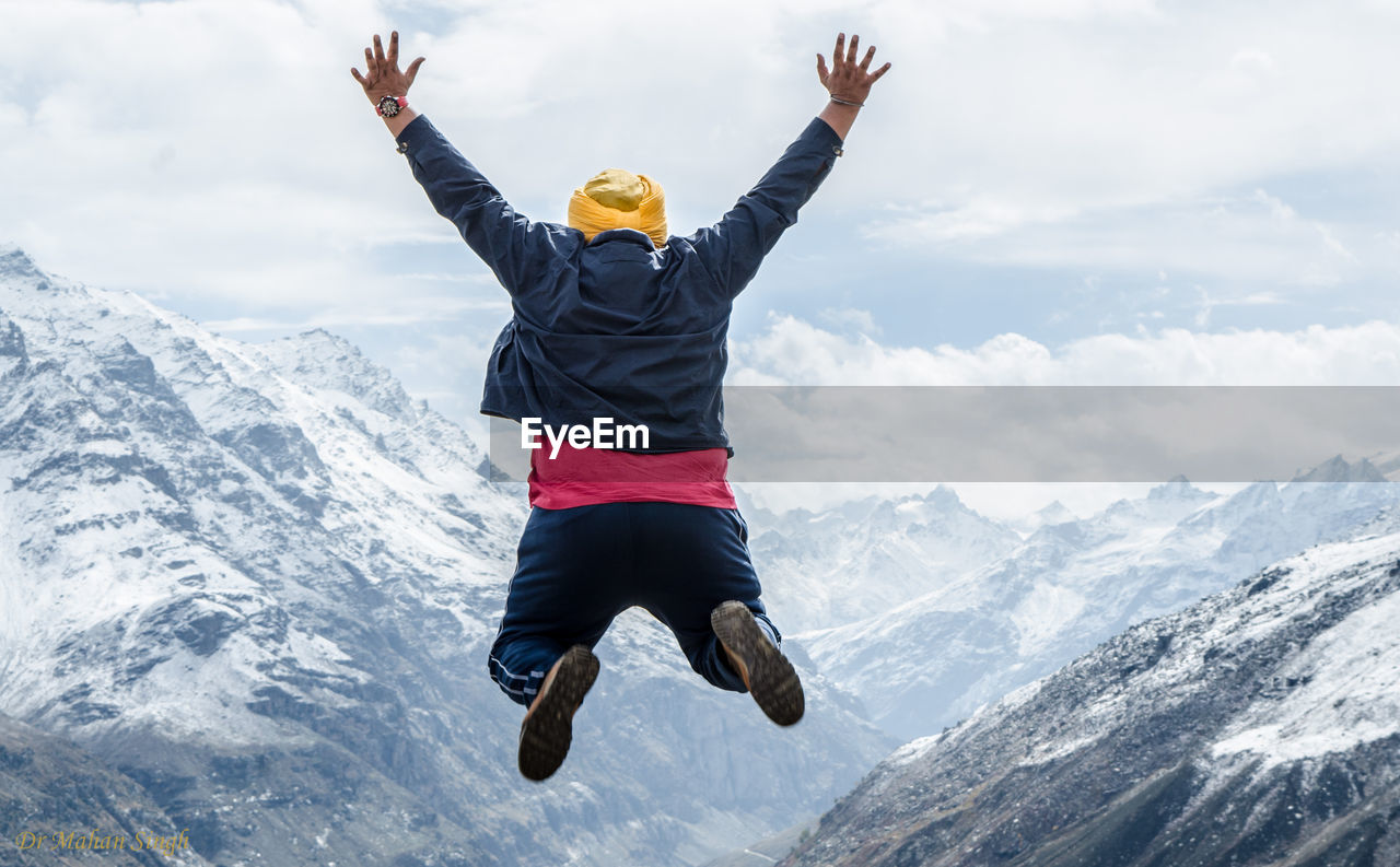 Low angle view of person paragliding against sky