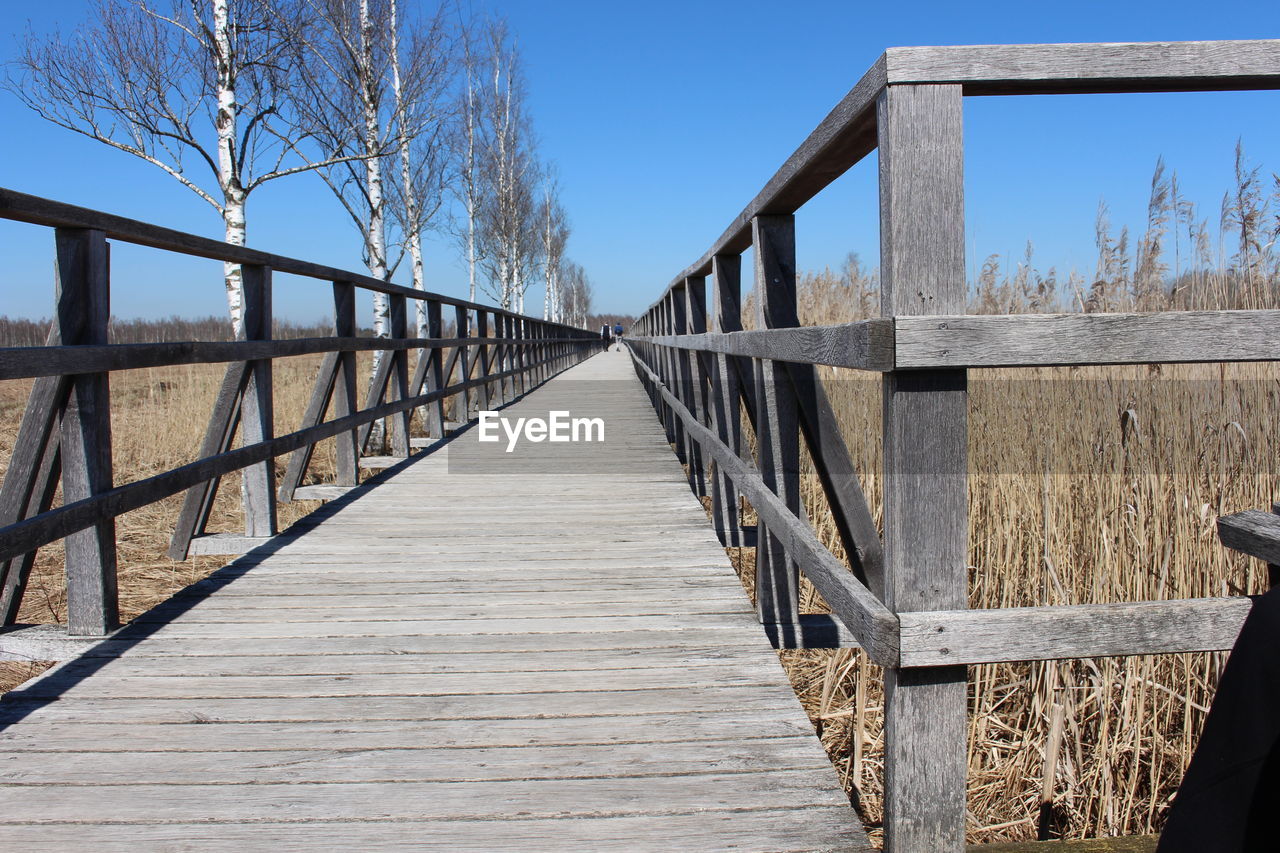 View of footbridge against sky