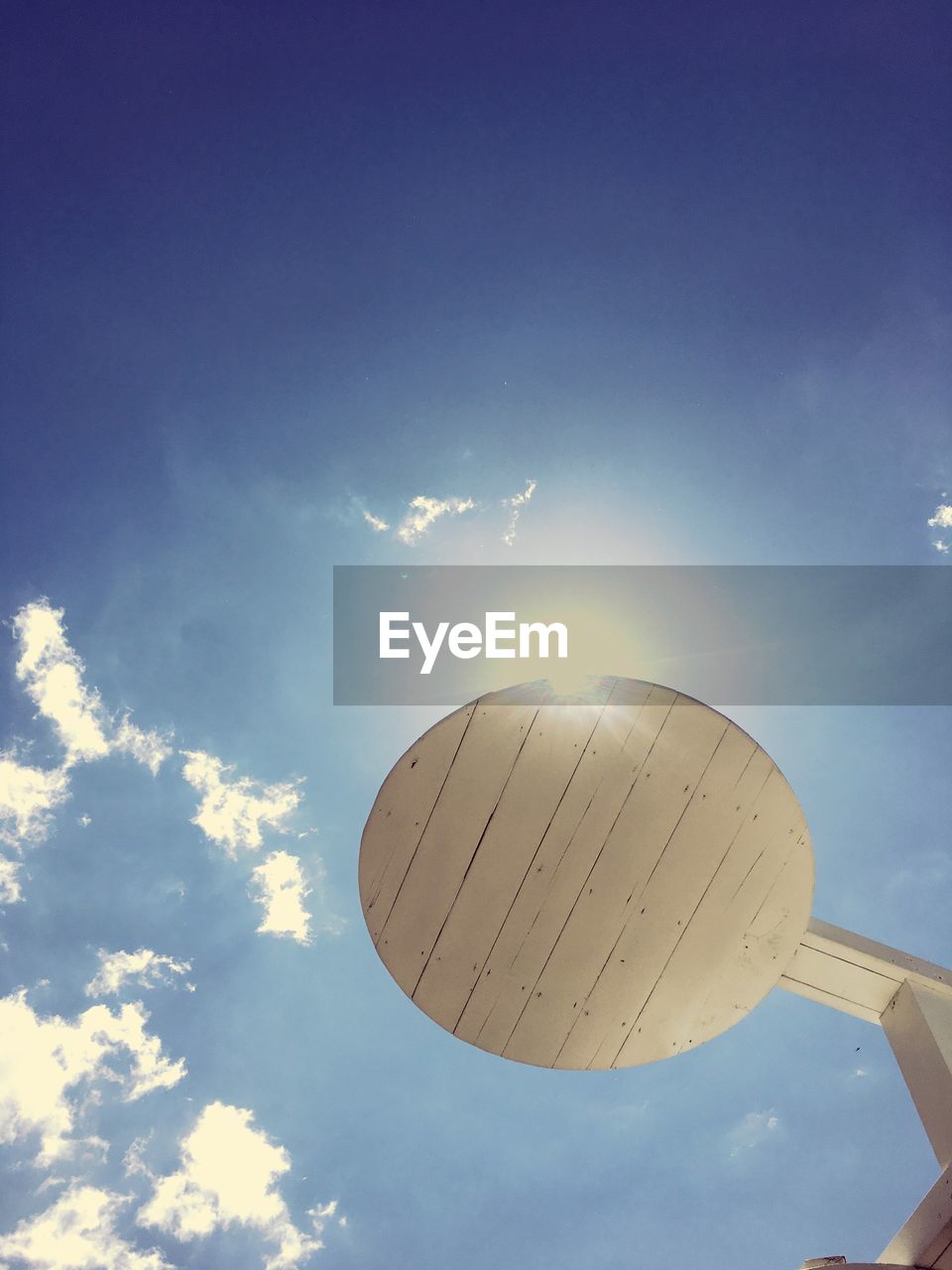 LOW ANGLE VIEW OF SKY AND CLOUDS IN SUNLIGHT AGAINST THE BACKGROUND