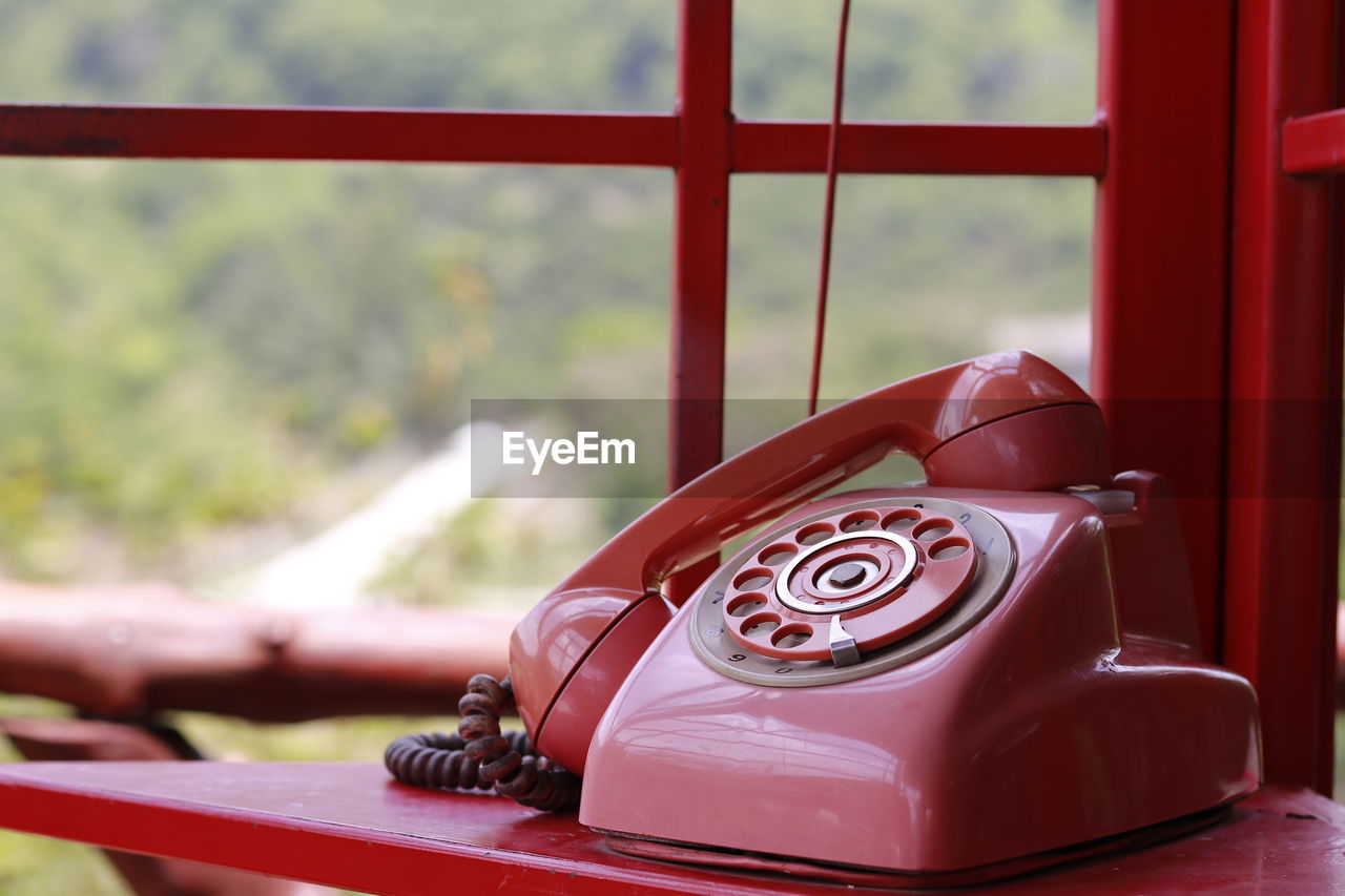 CLOSE-UP OF VINTAGE TELEPHONE ON TABLE