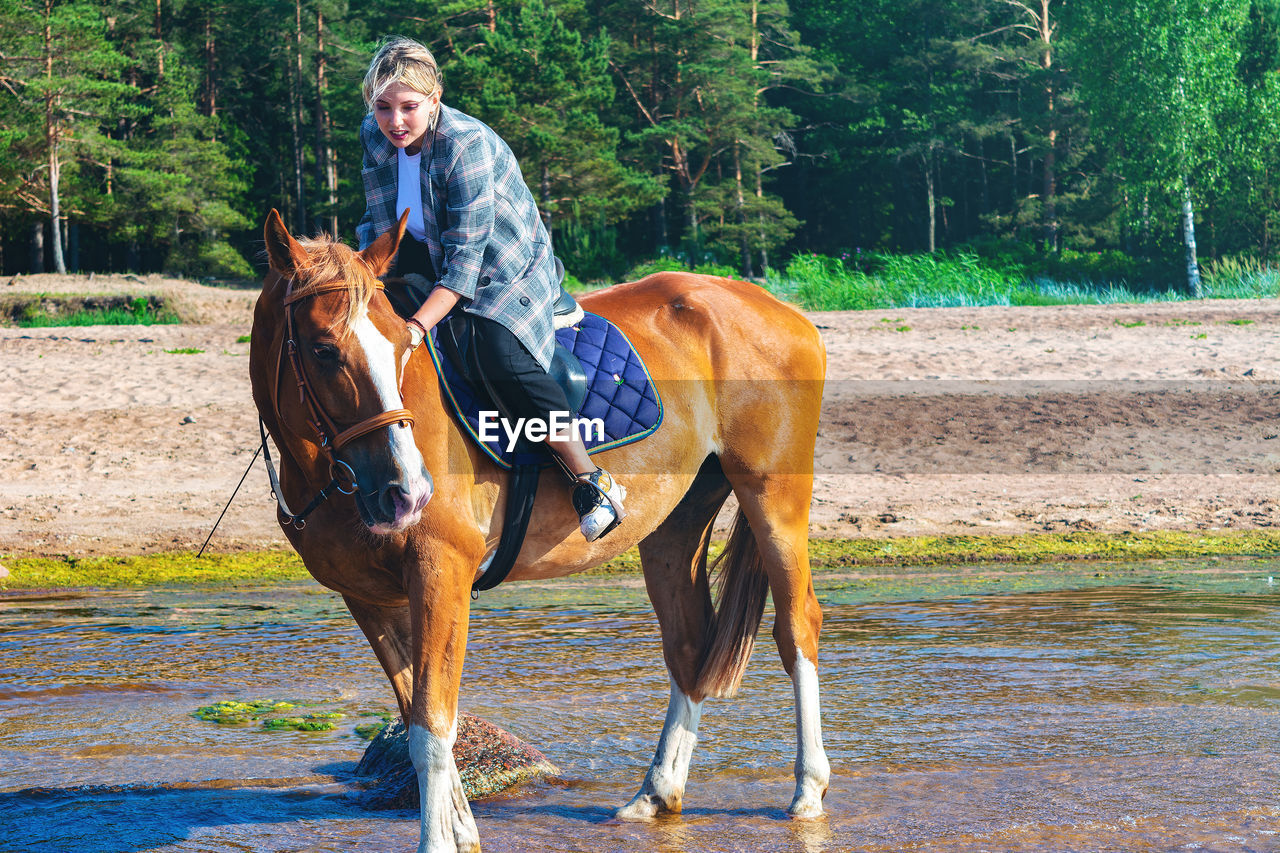 YOUNG MAN RIDING HORSE