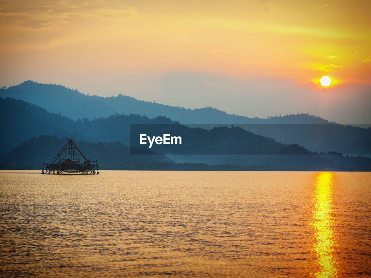 Scenic view of sea against orange sky