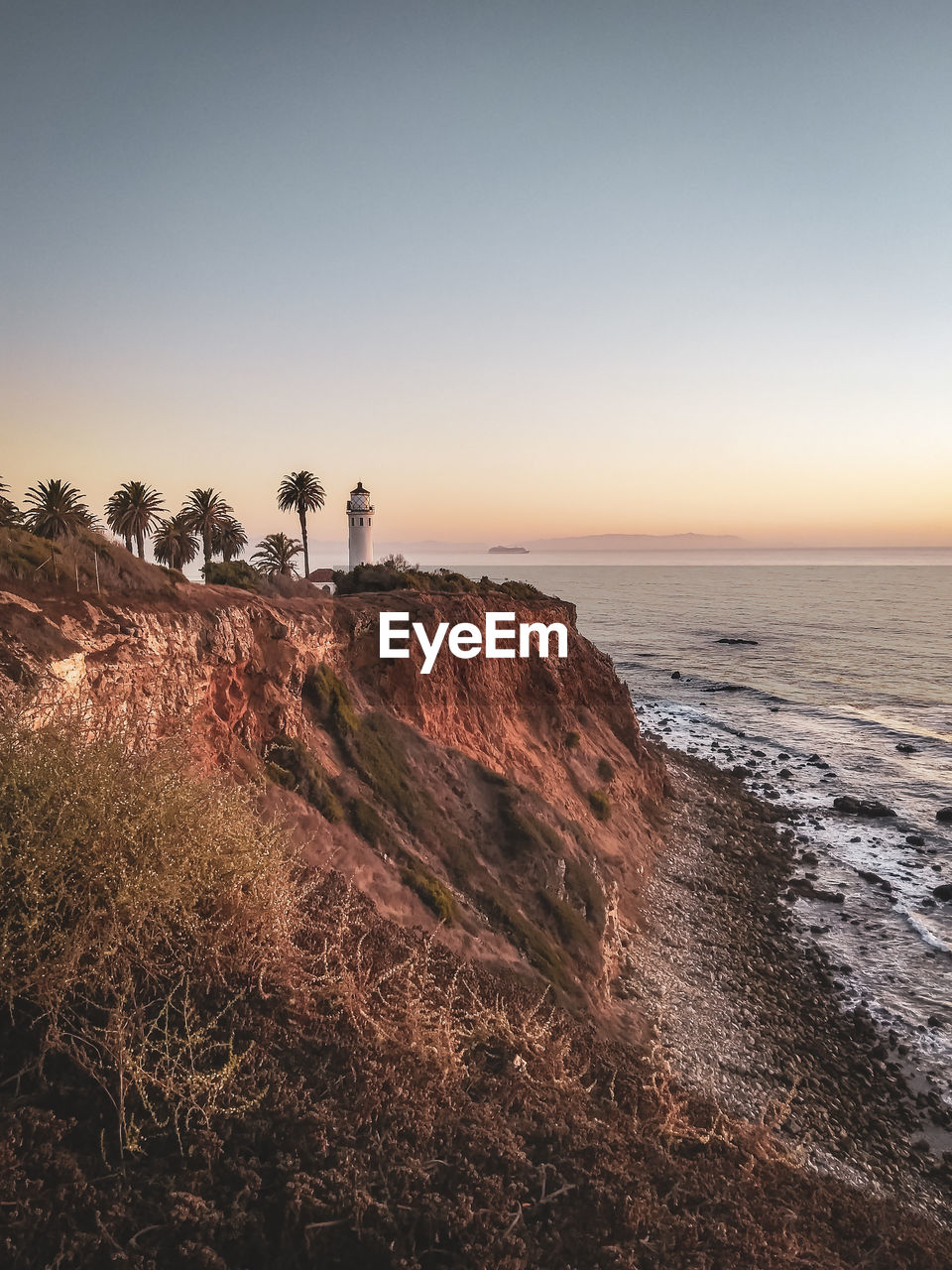 Scenic view of sea and mountains against sky during sunset