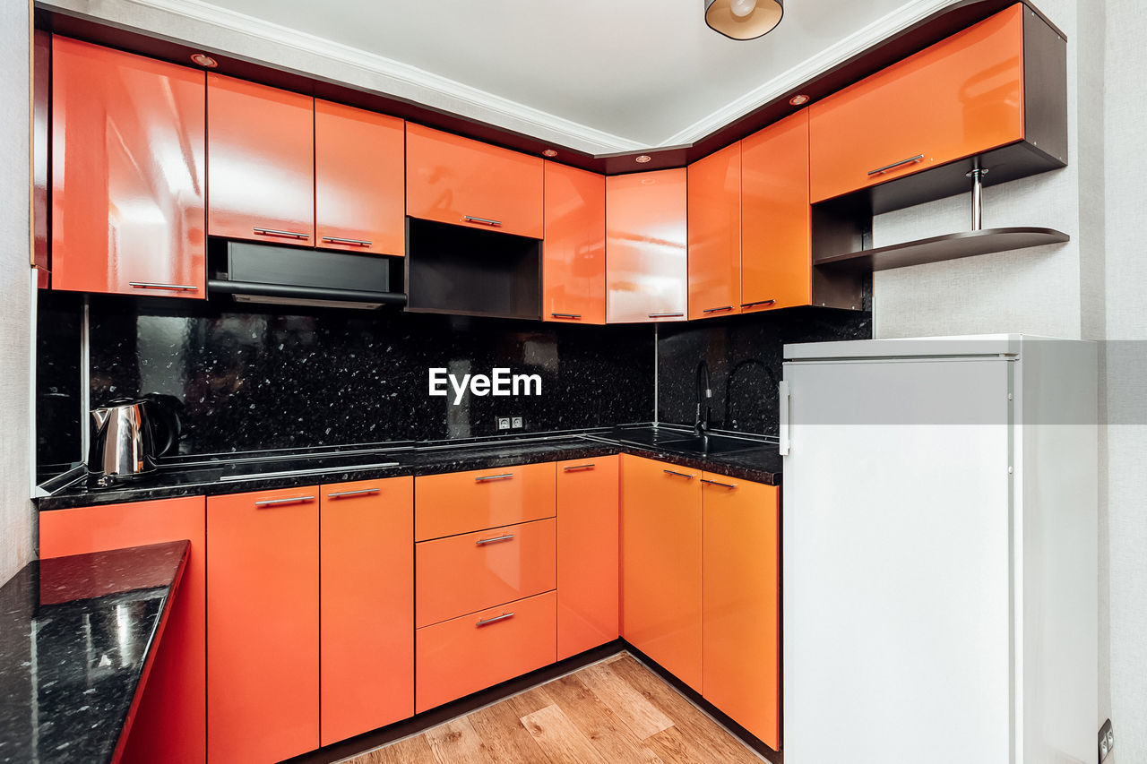 Modern orange kitchen with appliances