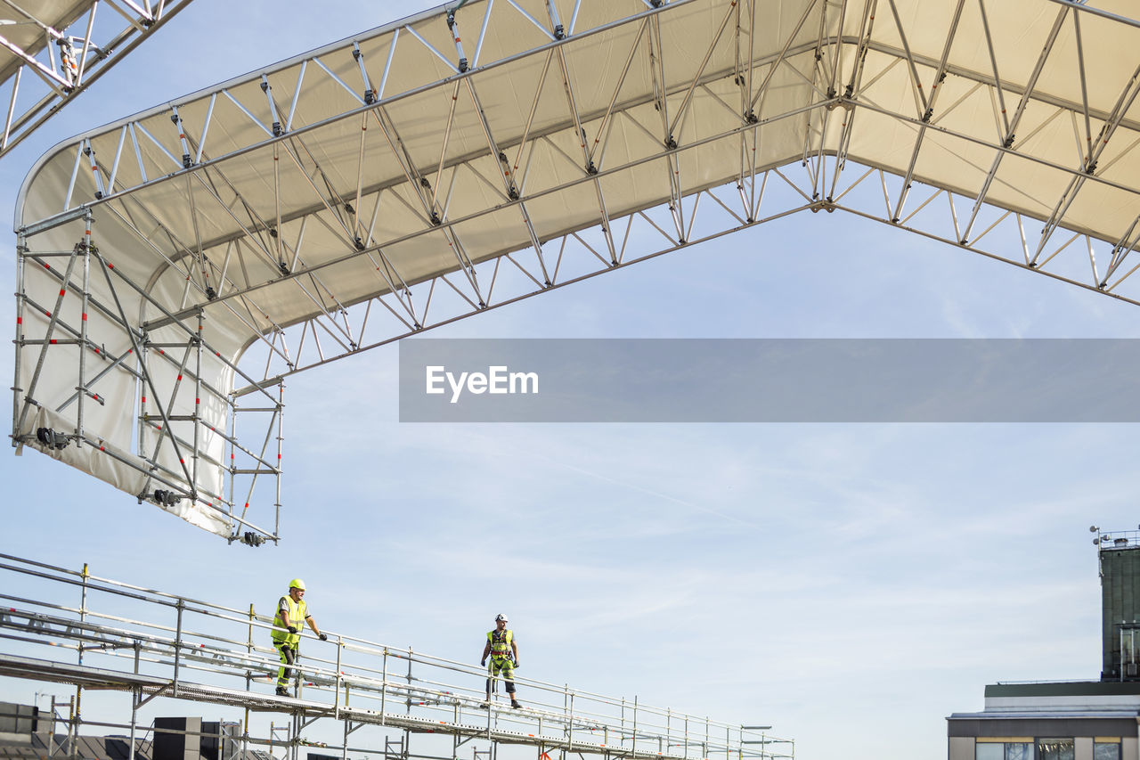 Workers on scaffolding at construction site