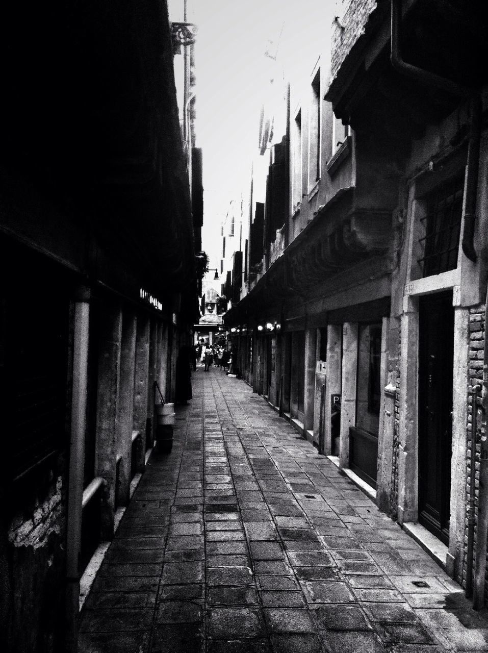 NARROW ALLEY WITH BUILDINGS IN BACKGROUND