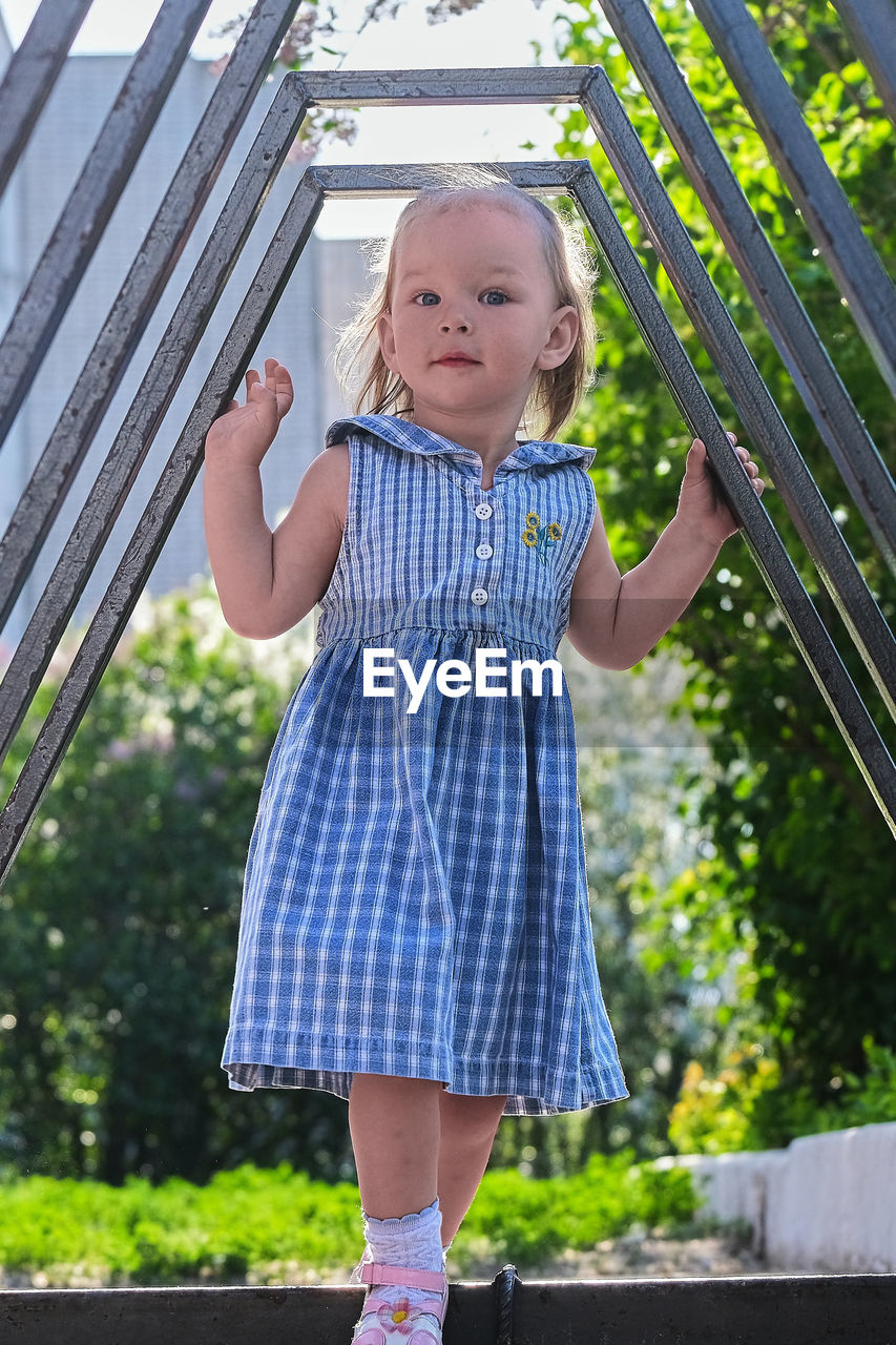 Portrait of cute girl standing in park