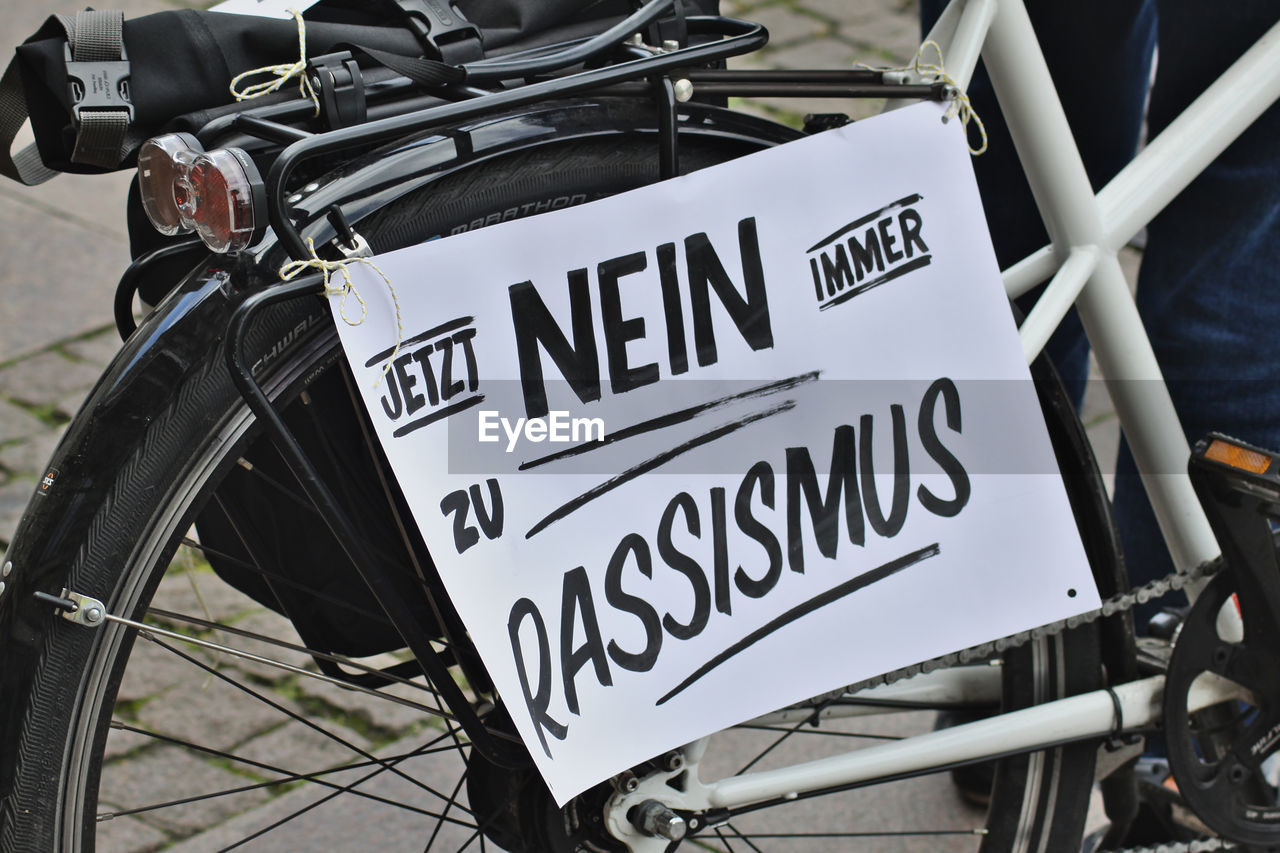 Close-up of bicycle with sign on street