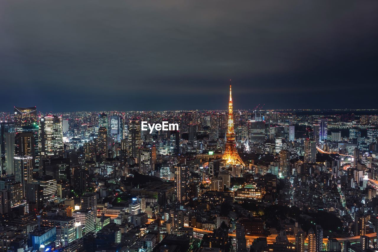 Illuminated city against sky at night