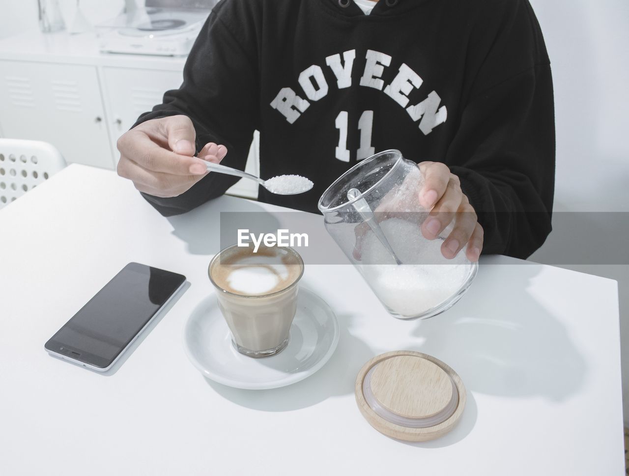 MAN HOLDING COFFEE CUP AND DRINK