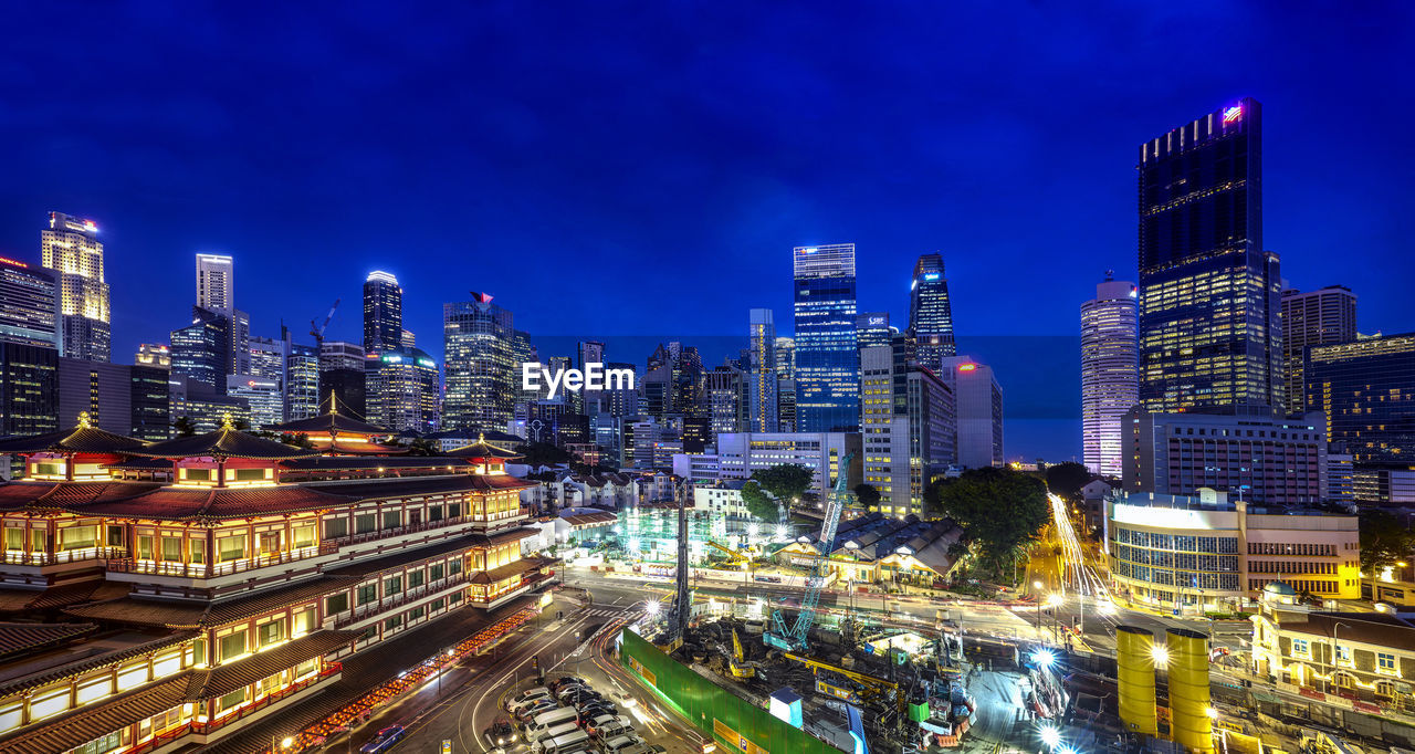 Illuminated modern buildings in city at night