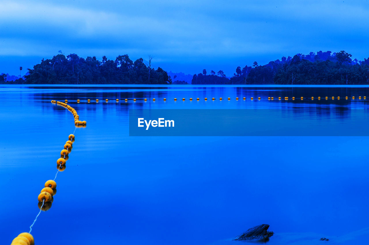 Scenic view of lake against blue sky