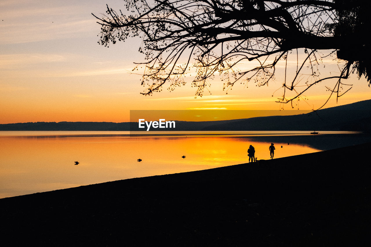 Scenic view of lake against orange sky