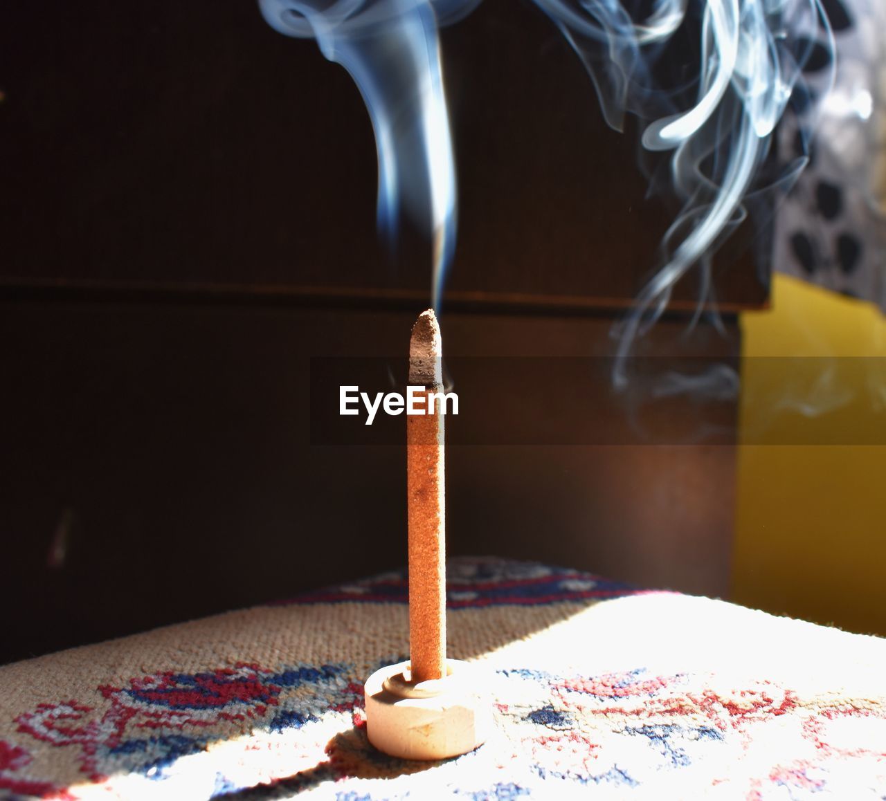 A essence stick with smoke in the air 