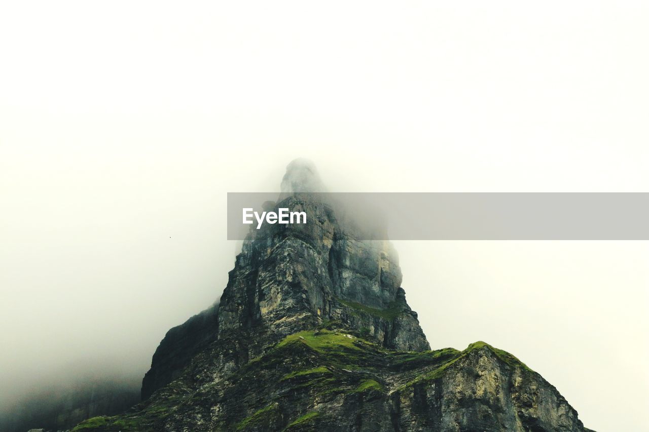 Low angle view of rock formation against sky