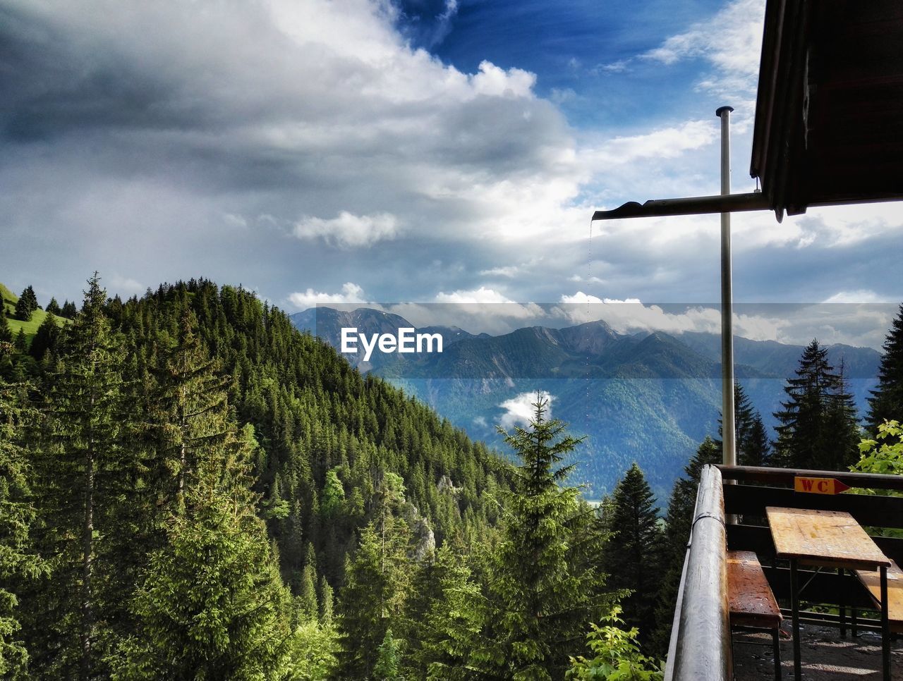 Scenic view of mountains against cloudy sky