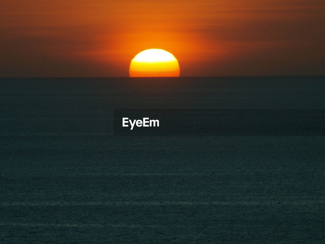 SCENIC VIEW OF SUNSET OVER SEA