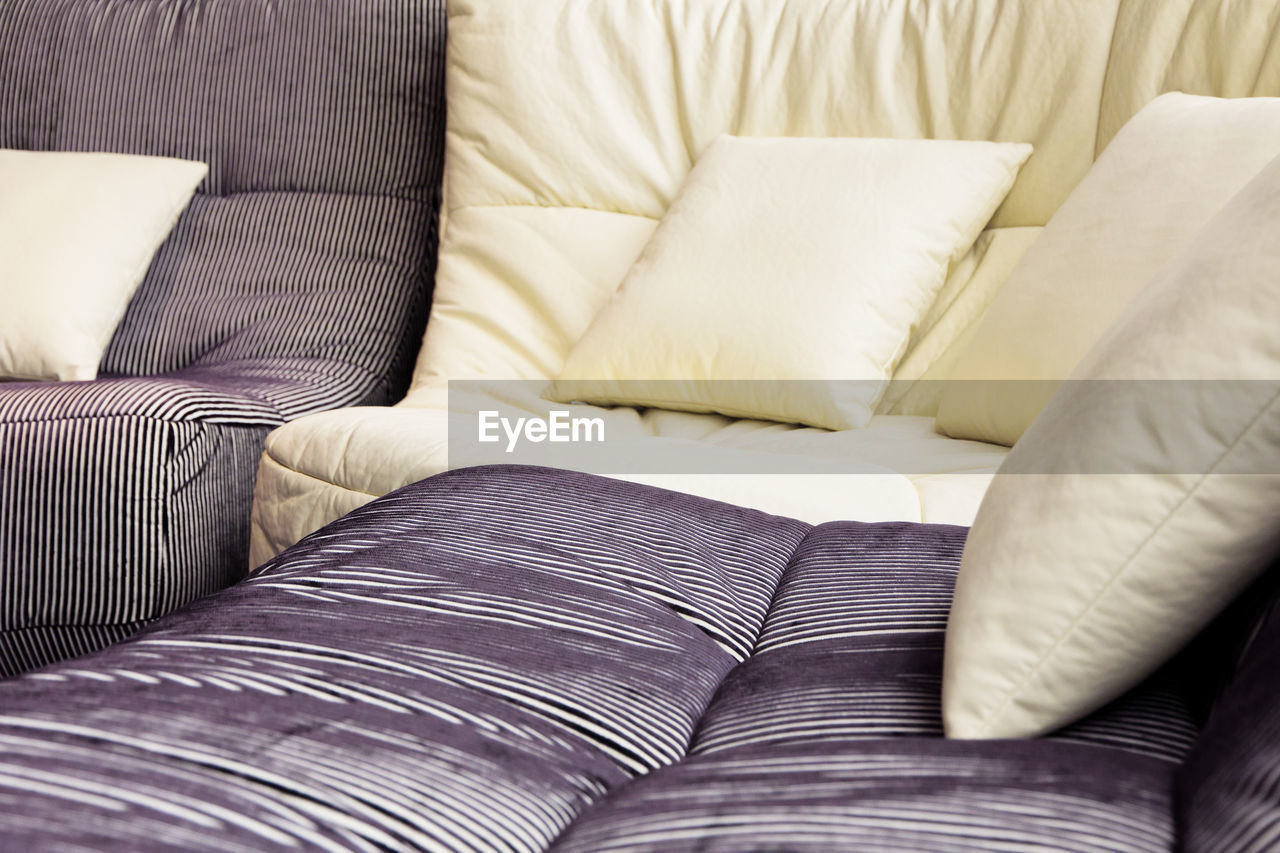 Close-up of cushions on sofa at home