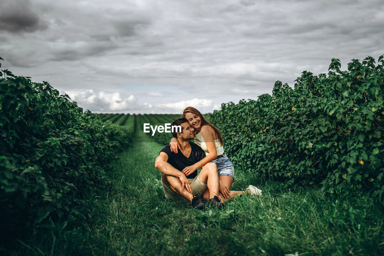 Couple on plants against sky