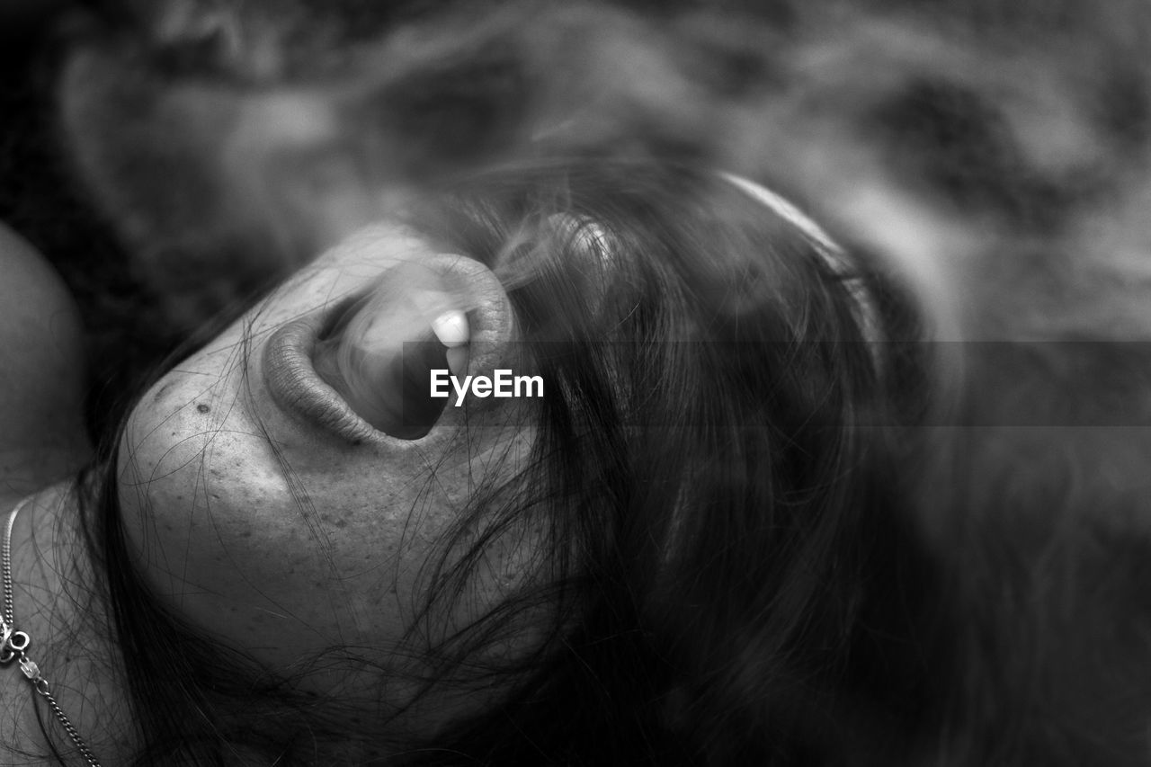 Close-up of young woman exhaling smoke