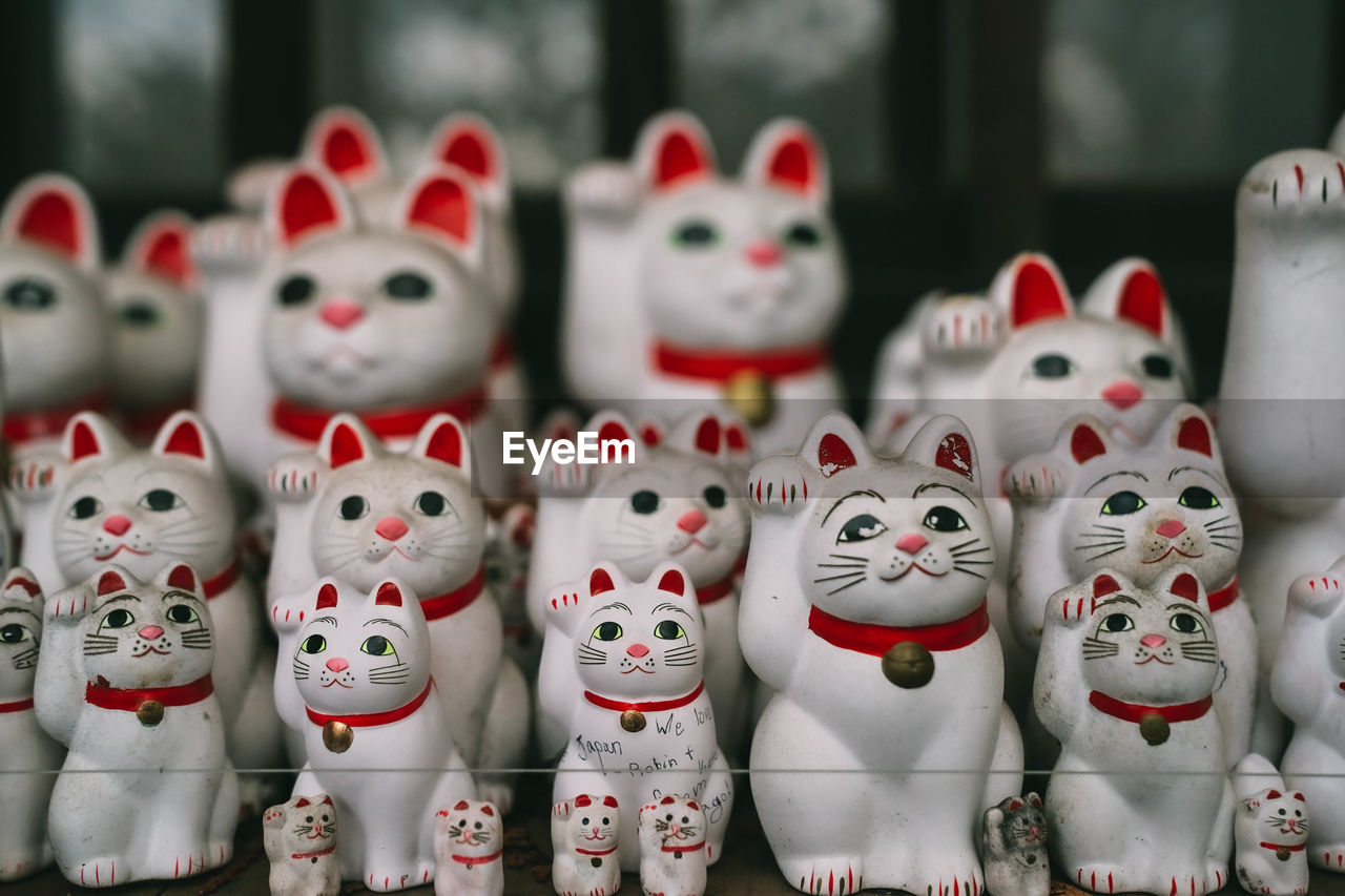 Close-up of maneki nekos for sale in market