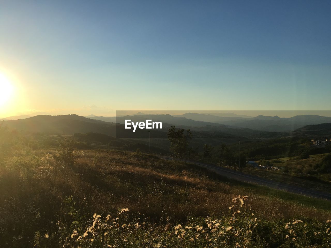 SCENIC VIEW OF AGRICULTURAL FIELD AGAINST SKY DURING SUNSET