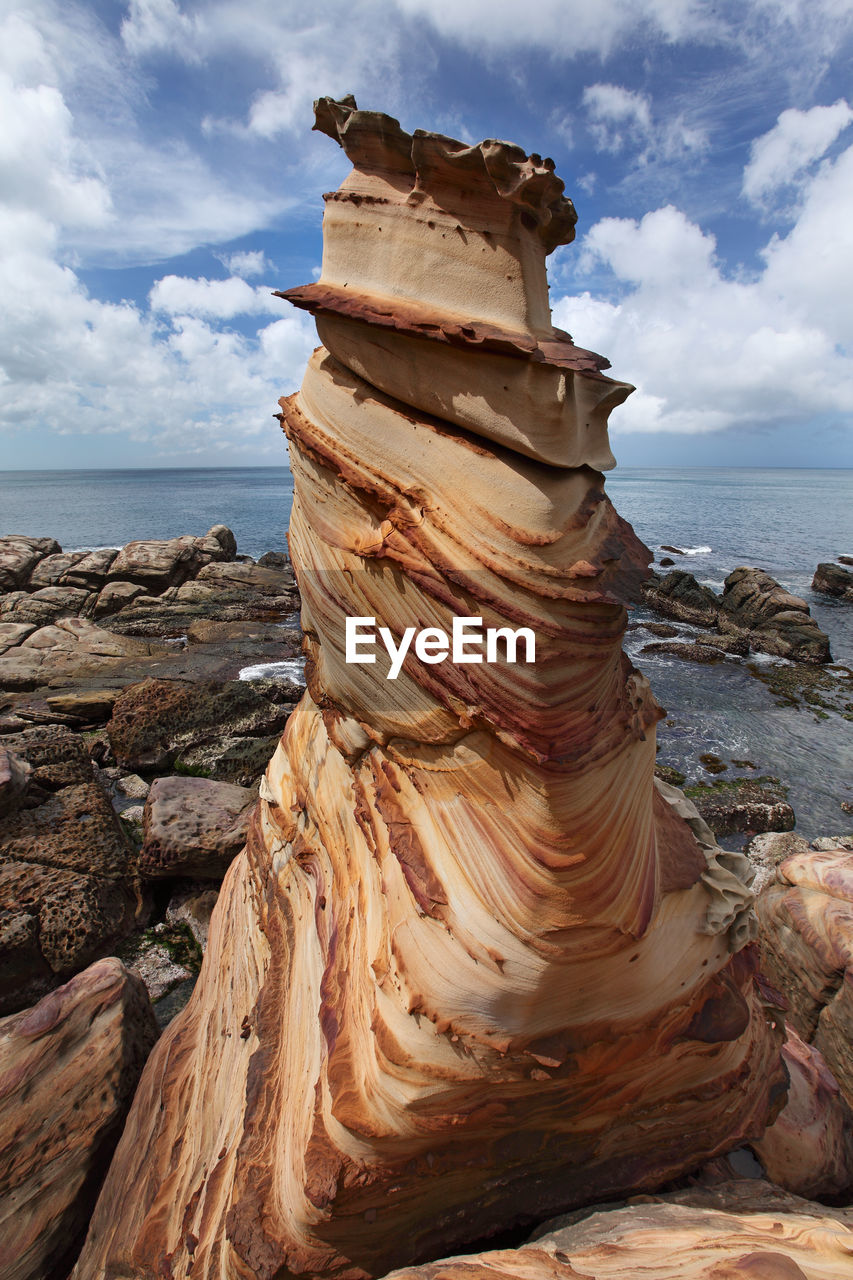 SCENIC VIEW OF ROCK FORMATION AT BEACH AGAINST SKY